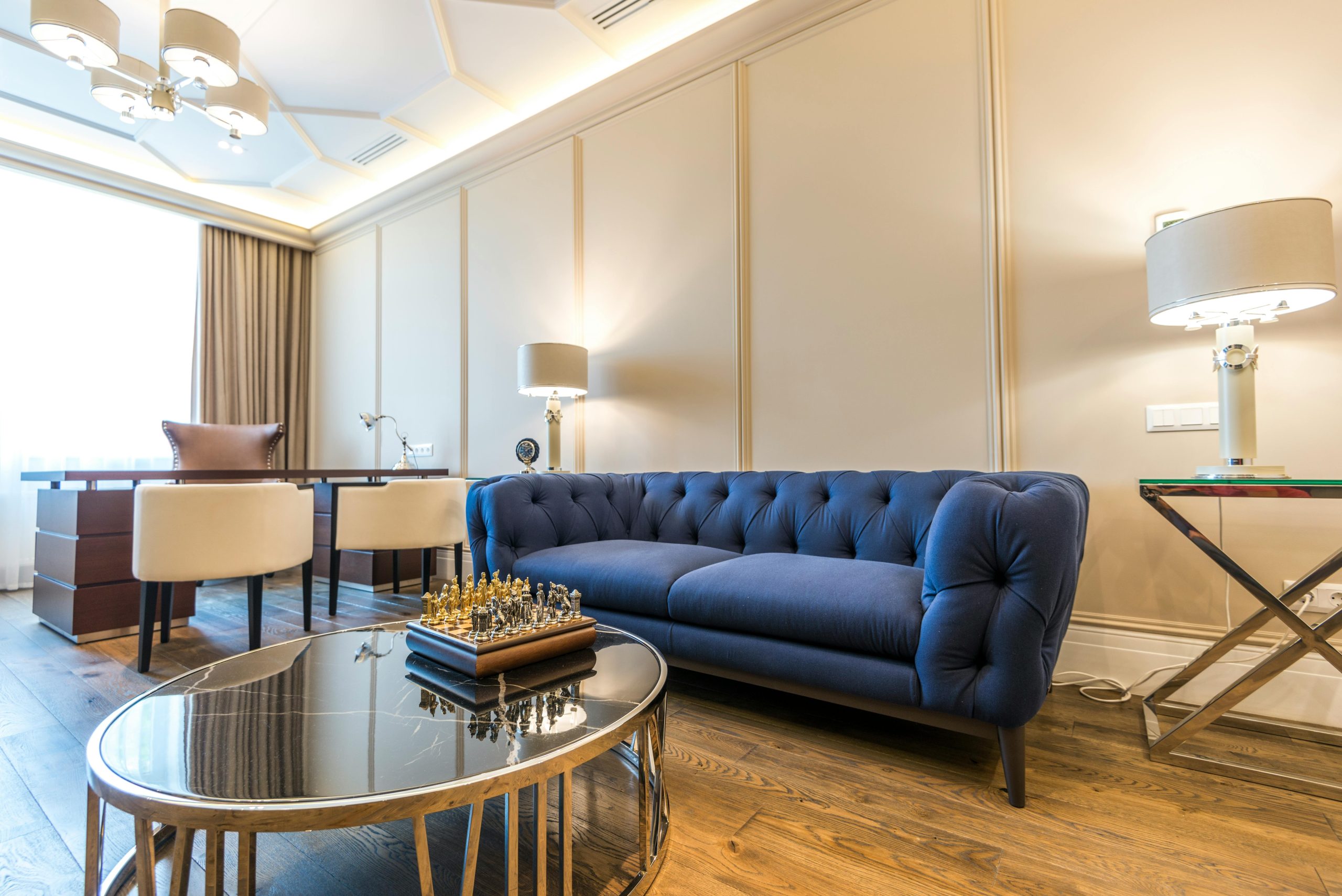 A stylish living room with blue furniture arranged around a coffee table, offering a comfortable space for relaxation